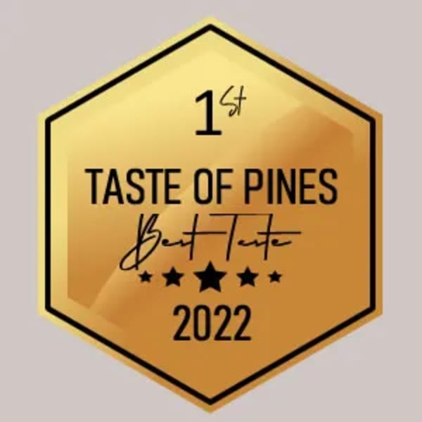 Gold hexagonal award for "1st Taste of Pines Best Taste 2022" with five stars.