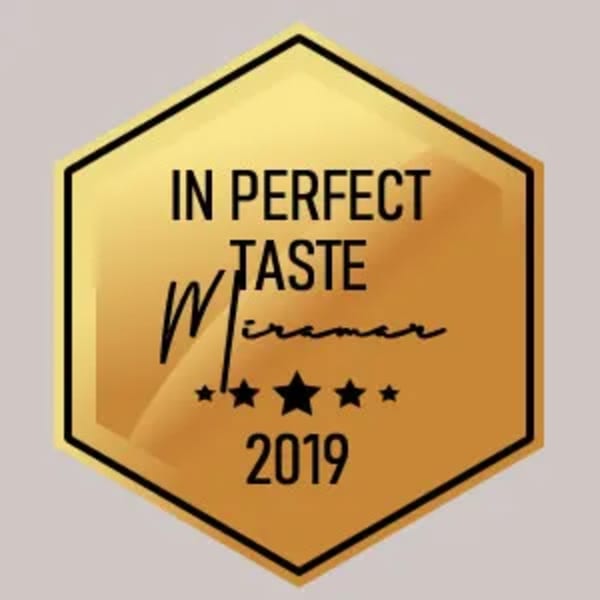 Golden hexagonal award with text "In Perfect Taste Miramar 2019" and five stars.