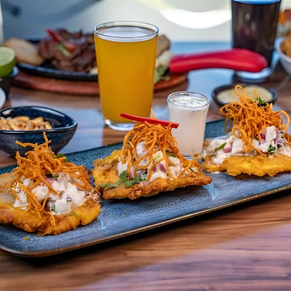 Three Peruvian Cebiche-Bar tostones topped with ceviche, crispy sweet potato, and aji pepper.